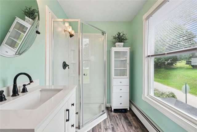203 E Main St, New Alexandria, PA 15670 - full bathroom with a baseboard heating unit, wood finished floors, a stall shower, and healthy amount of natural light