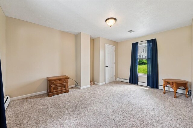 203 E Main St, New Alexandria, PA 15670 - empty room with baseboard heating, carpet flooring, and baseboards