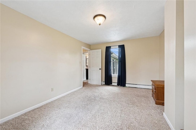 203 E Main St, New Alexandria, PA 15670 - spare room with carpet, baseboards, and a baseboard radiator