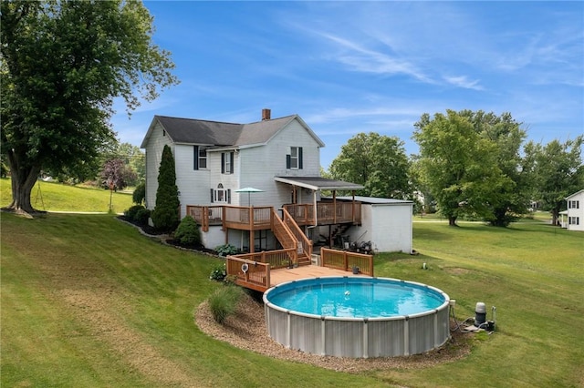 203 E Main St, New Alexandria, PA 15670 - rear view of house featuring a deck, stairs, a yard, and a chimney