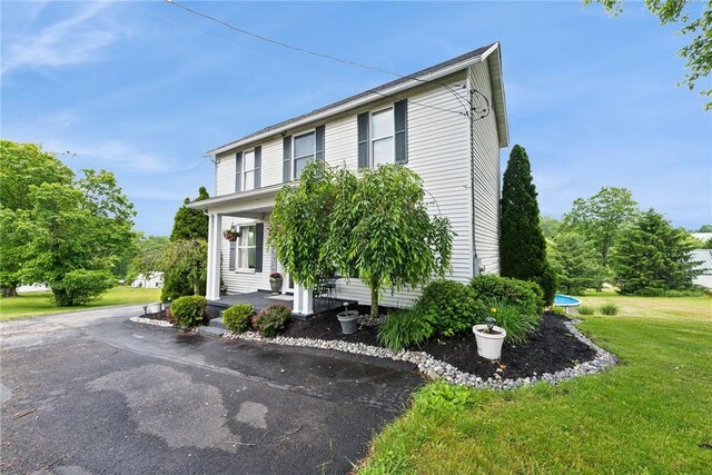 203 E Main St, New Alexandria, PA 15670 - view of front facade with a front lawn and covered porch