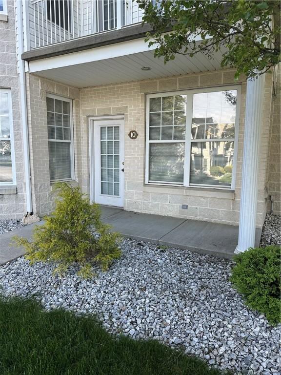 234 Adams Pointe Blvd Unit 10, Adams Twp, PA 16046 - property entrance featuring a balcony and brick siding