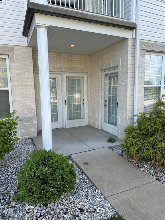 234 Adams Pointe Blvd Unit 10, Adams Twp, PA 16046 - view of exterior entry with brick siding and a balcony