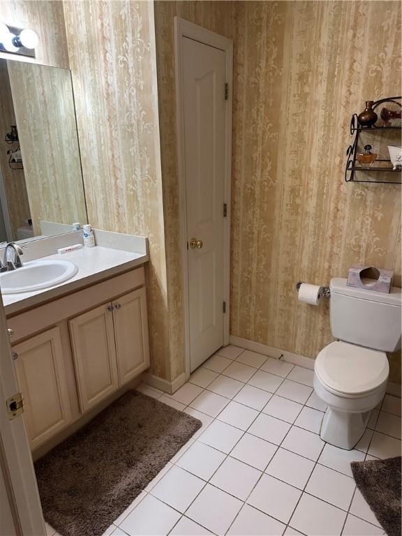 234 Adams Pointe Blvd Unit 10, Adams Twp, PA 16046 - bathroom featuring vanity, wallpapered walls, tile patterned flooring, toilet, and baseboards