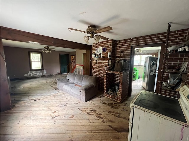 140 Smartnick Rd, Hempfield Twp Wml, PA 15601 - living area featuring a ceiling fan, a fireplace, hardwood / wood-style flooring, and brick wall