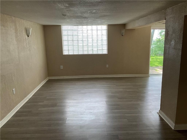 157 Suncrest Dr, Verona, PA 15147 - unfurnished room featuring dark wood-style flooring, a textured wall, baseboards, and a textured ceiling