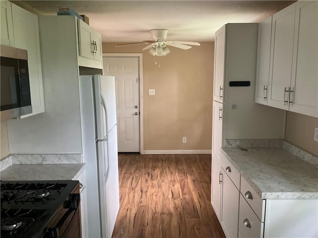 157 Suncrest Dr, Verona, PA 15147 - kitchen featuring wood finished floors, ceiling fan, stainless steel microwave, black range with gas stovetop, and freestanding refrigerator