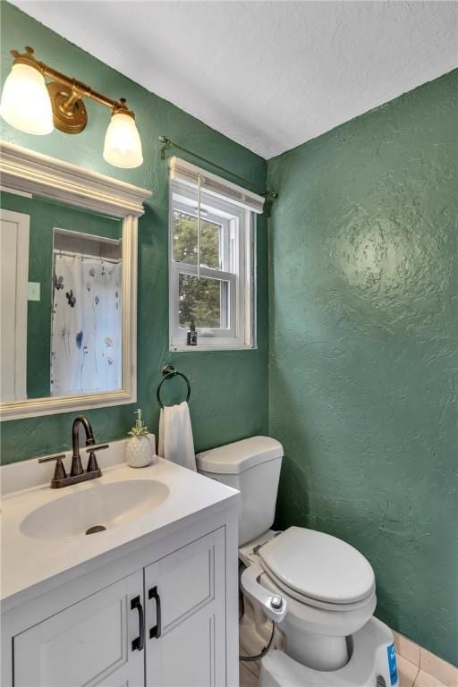 600 Buckingham Dr, Hempfield Twp, PA 15601 - bathroom with toilet, vanity, tile patterned floors, and a textured wall