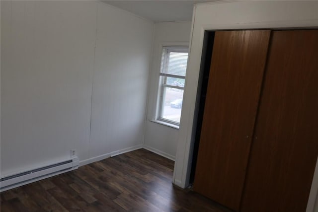 165 W Wylie Ave, City Of Washington, PA 15301 - unfurnished bedroom featuring a baseboard radiator, multiple windows, dark wood-style floors, and a closet