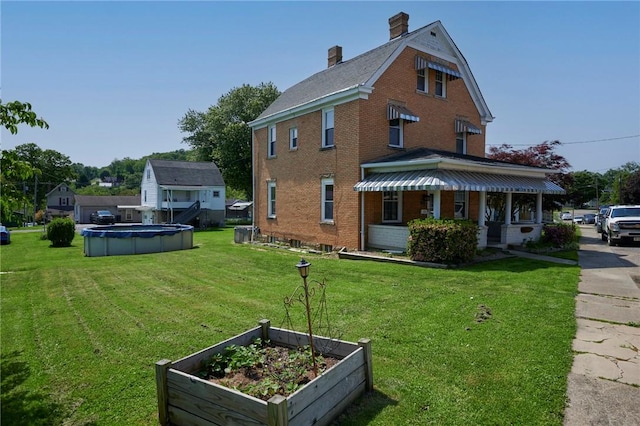 320 Garfield St, W Kittanning Boro, PA 16201 - view of home's exterior with a yard, a garden, and brick siding