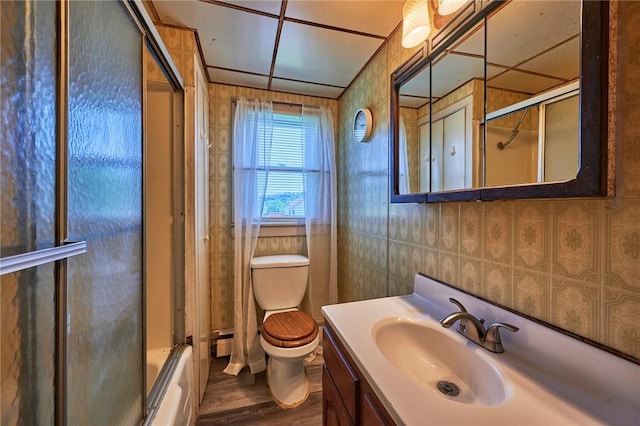 320 Garfield St, W Kittanning Boro, PA 16201 - bathroom featuring toilet, vanity, bath / shower combo with glass door, wood finished floors, and baseboard heating