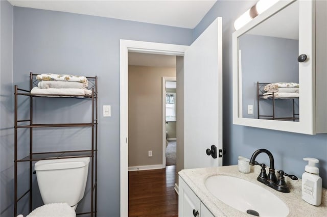 452 Clark Hollow Rd, Fairfield Twp, PA 15944 - half bathroom with wood finished floors, vanity, toilet, and baseboards