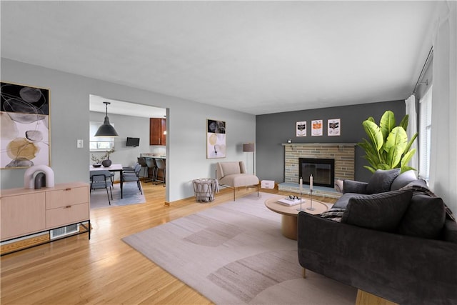 127 Craig Dr, Hempfield Twp Wml, PA 15601 - living room featuring light wood-type flooring and a brick fireplace