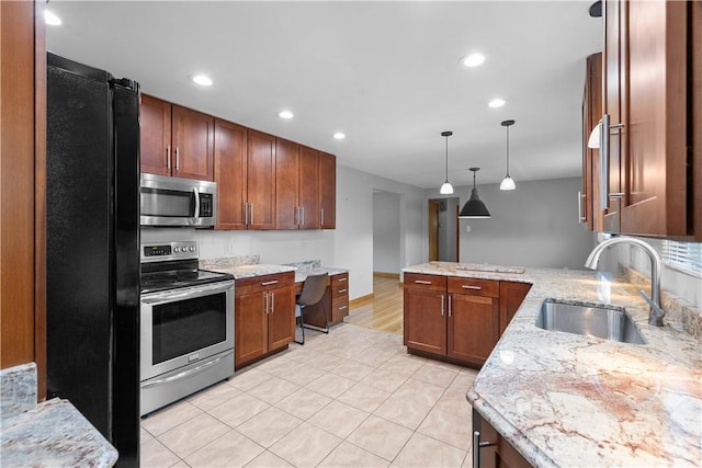 127 Craig Dr, Hempfield Twp Wml, PA 15601 - kitchen with stainless steel appliances, a sink, a peninsula, light tile patterned flooring, and recessed lighting