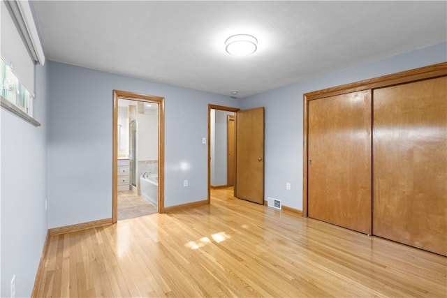 127 Craig Dr, Hempfield Twp Wml, PA 15601 - unfurnished bedroom with light wood finished floors, baseboards, a closet, and connected bathroom