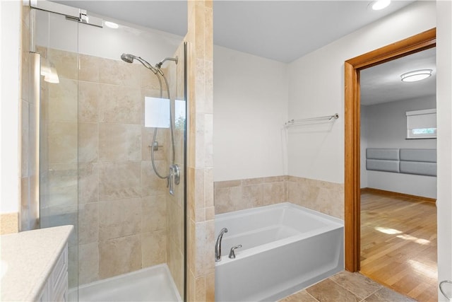 127 Craig Dr, Hempfield Twp Wml, PA 15601 - bathroom with a shower stall, a garden tub, and vanity