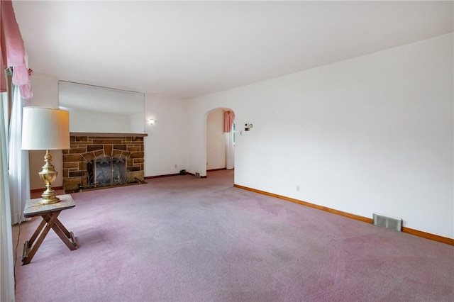 420 N St, Springdale Boro, PA 15144 - unfurnished living room with arched walkways, carpet, baseboards, and a fireplace