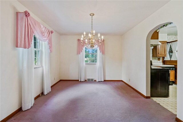 420 N St, Springdale Boro, PA 15144 - unfurnished dining area with plenty of natural light, light carpet, a chandelier, and baseboards