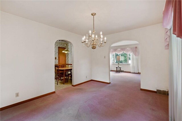 420 N St, Springdale Boro, PA 15144 - empty room with arched walkways, carpet flooring, baseboards, and a chandelier