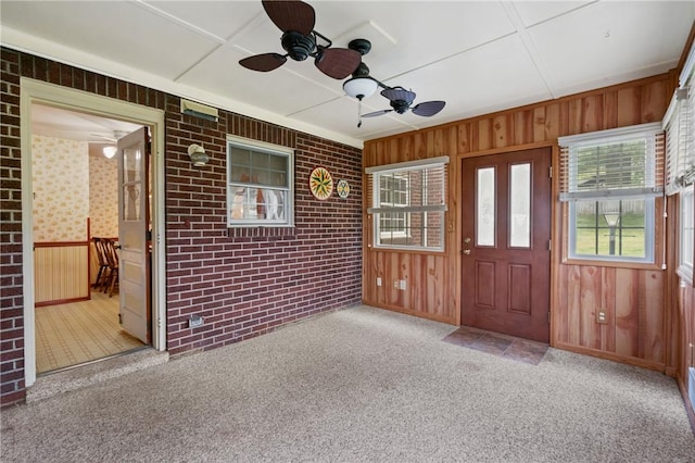 420 N St, Springdale Boro, PA 15144 - entryway featuring carpet, ceiling fan, wooden walls, and brick wall