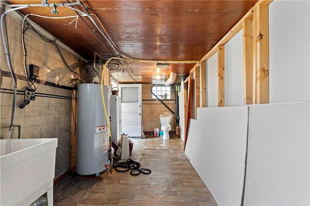 2715 Merwyn Ave, Sheraden, PA 15204 - below grade area featuring gas water heater, a sink, and wood finished floors