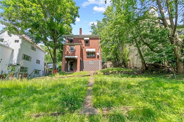 2715 Merwyn Ave, Sheraden, PA 15204 - rear view of house with brick siding and a chimney