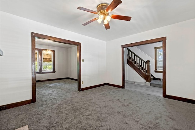 2715 Merwyn Ave, Sheraden, PA 15204 - carpeted spare room with baseboards, stairs, a ceiling fan, and a chandelier