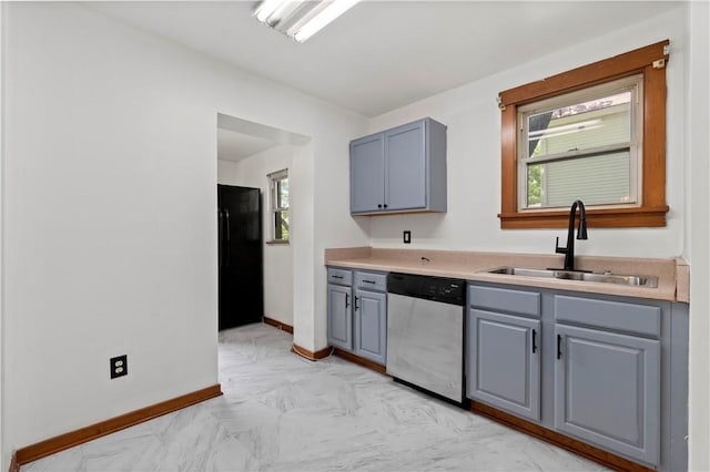 2715 Merwyn Ave, Sheraden, PA 15204 - kitchen with stainless steel dishwasher, a sink, gray cabinetry, freestanding refrigerator, and baseboards