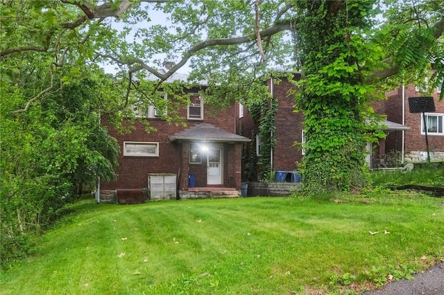 3855 Hiawatha St, Brighton Heights, PA 15212 - rear view of property with a lawn and brick siding