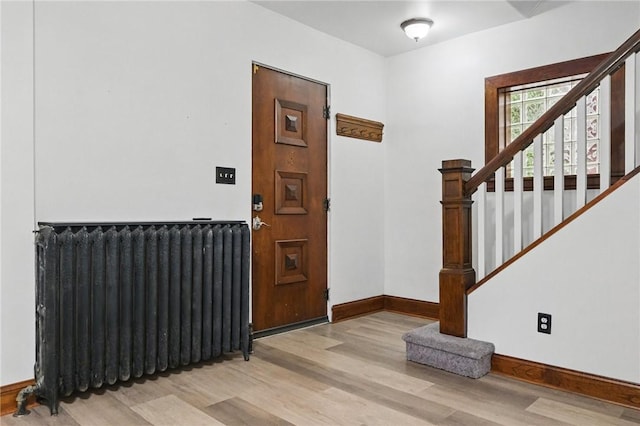 3855 Hiawatha St, Brighton Heights, PA 15212 - entrance foyer with radiator heating unit, light wood-style floors, baseboards, and stairs