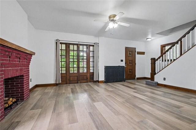 3855 Hiawatha St, Brighton Heights, PA 15212 - unfurnished living room featuring wood finished floors, stairs, a ceiling fan, baseboards, and a fireplace