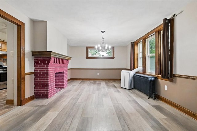 3855 Hiawatha St, Brighton Heights, PA 15212 - unfurnished dining area featuring radiator, radiator heating unit, light wood-style floors, and baseboards