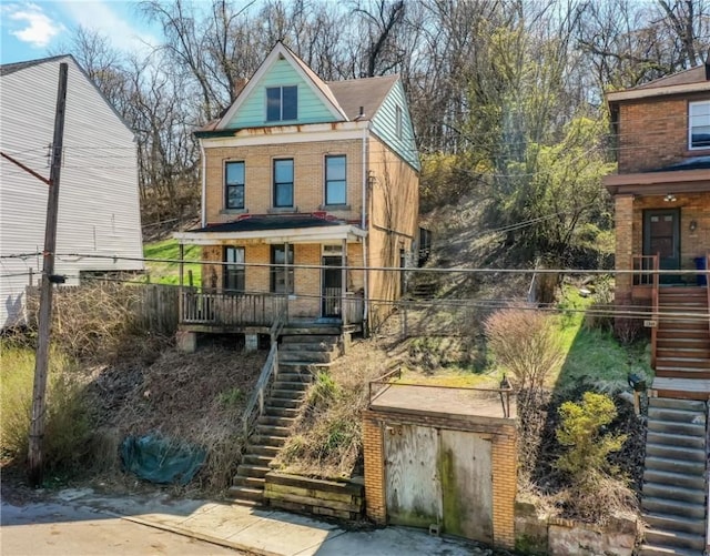 1339 Romanhoff St, Spring Hill, PA 15212 - view of front of property with stairs, brick siding, and a porch