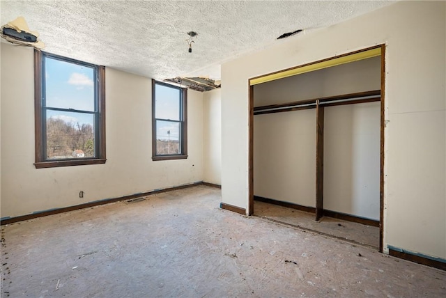 1339 Romanhoff St, Spring Hill, PA 15212 - unfurnished bedroom with a textured ceiling, a closet, and baseboards