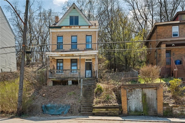 1339 Romanhoff St, Spring Hill, PA 15212 - view of front of house featuring brick siding, a porch, stairway, and a chimney