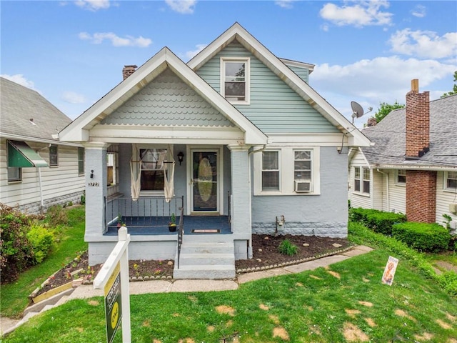 3722 Millerton Ave, Brighton Heights, PA 15212 - view of front facade with a porch, a front lawn, a chimney, and cooling unit