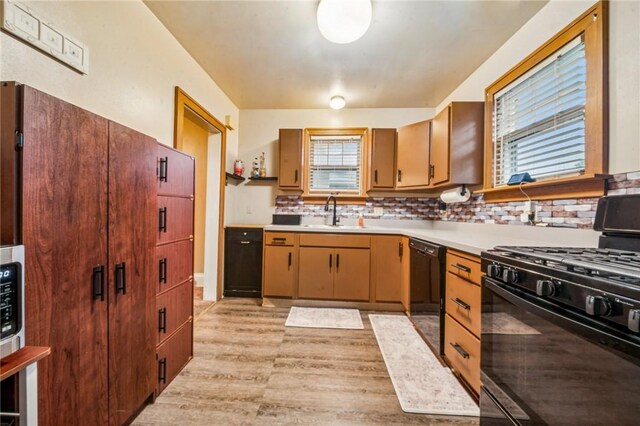 3722 Millerton Ave, Brighton Heights, PA 15212 - kitchen featuring black appliances, light countertops, light wood-style floors, a sink, and decorative backsplash