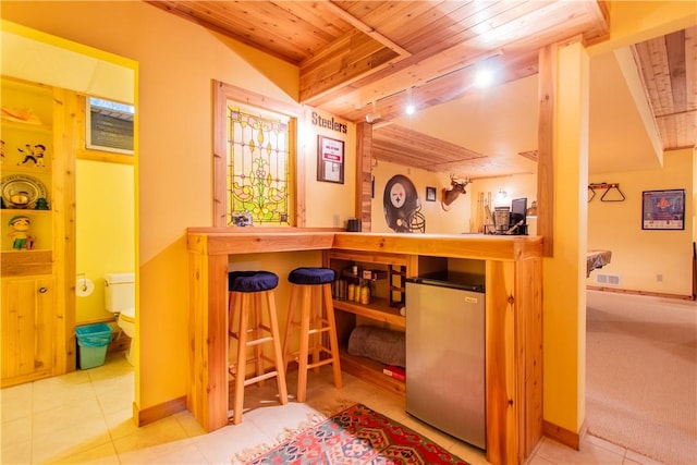 101 Timber Ct, Franklin Twp But, PA 16052 - bar with wooden ceiling, tile patterned floors, stainless steel refrigerator, and baseboards