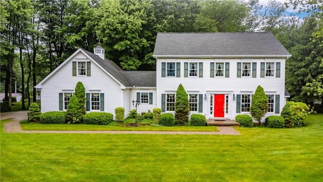 101 Timber Ct, Franklin Twp But, PA 16052 - colonial home featuring a front lawn, a shingled roof, and view of scattered trees