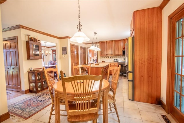 101 Timber Ct, Franklin Twp But, PA 16052 - dining area featuring light tile patterned flooring, baseboards, crown molding, and a chandelier