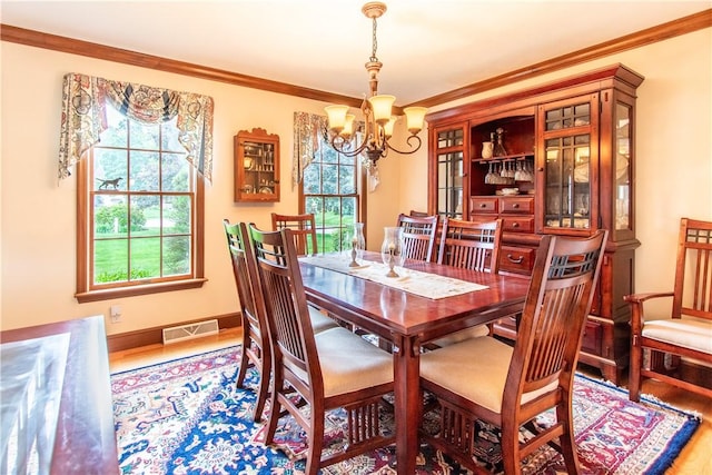 101 Timber Ct, Franklin Twp But, PA 16052 - dining area with a chandelier, wood finished floors, crown molding, and baseboards