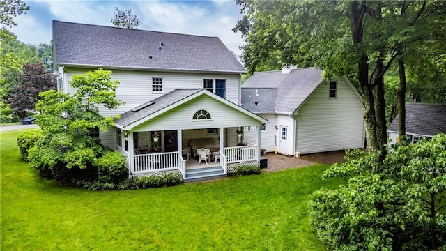 101 Timber Ct, Franklin Twp But, PA 16052 - rear view of property with a yard, covered porch, and roof with shingles