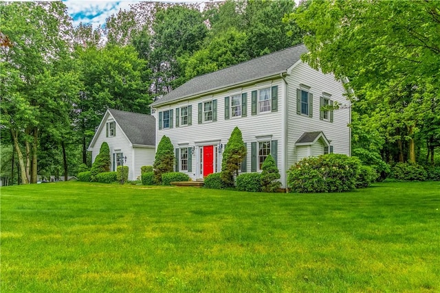 101 Timber Ct, Franklin Twp But, PA 16052 - colonial inspired home with a front lawn, view of wooded area, and a shingled roof