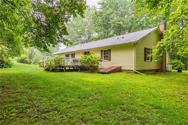 287 Hungarian Rd, Slippery Rock Twp But, PA 16057 - rear view of house with a deck, a chimney, and a lawn