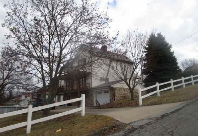 1860 Ohio Ave, West Mifflin, PA 15122 - view of property exterior with stone siding, a garage, and a chimney