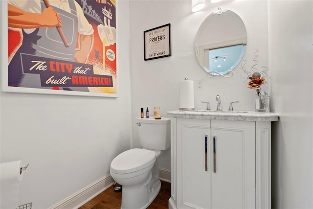 2700 Sumner St, South Side, PA 15203 - half bath with toilet, vanity, wood finished floors, and baseboards
