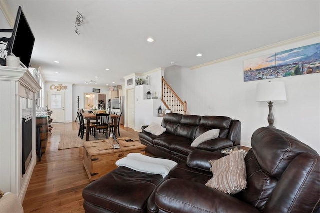 2700 Sumner St, South Side, PA 15203 - living room with a fireplace, stairs, light wood-style flooring, recessed lighting, and ornamental molding