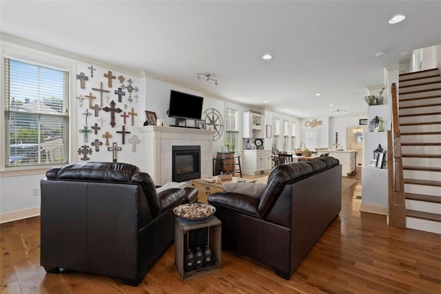 2700 Sumner St, South Side, PA 15203 - living room with wood finished floors, baseboards, stairs, a glass covered fireplace, and recessed lighting
