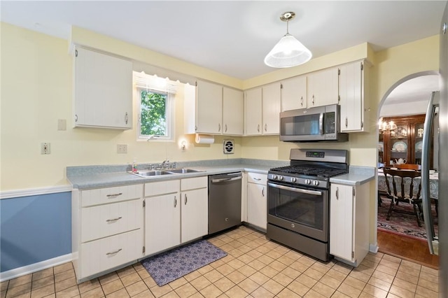 152 N Jamestown Rd, Moon/Crescent Twp, PA 15108 - kitchen featuring stainless steel appliances, arched walkways, light countertops, white cabinetry, and light tile patterned flooring