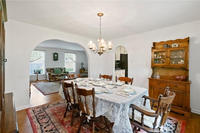 152 N Jamestown Rd, Moon/Crescent Twp, PA 15108 - dining area with arched walkways, dark wood-style floors, and a chandelier